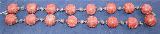 A Chinese cinnabar lacquer shou bead necklace, early 20th century length 37cm